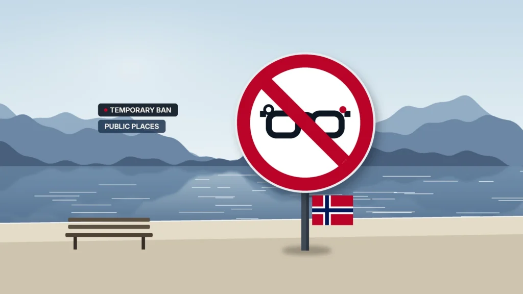 News illustration: a calm Norwegian fjord shoreline with mist-blue mountains, still water, a beach and a park bench; a large red prohibition sign on a post shows camera glasses with a record dot under a red slash, with a small Norwegian flag below; chips TEMPORARY BAN and PUBLIC PLACES.
