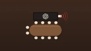 A top-down view of an empty conference room on a dark brown background: a wooden table ringed by cream chairs, a wall screen showing the OpenAI logo, and a small device plugged into the side of the screen with a red light and red signal arcs.
