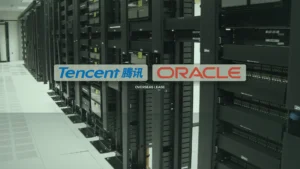 Photo of a data-center aisle of black server racks under a muted sage-and-pine color grade. Centered side-by-side on pale sage cards are the Tencent and Oracle wordmarks; a small dark strap below reads OVERSEAS LEASE. No masthead or chip row.